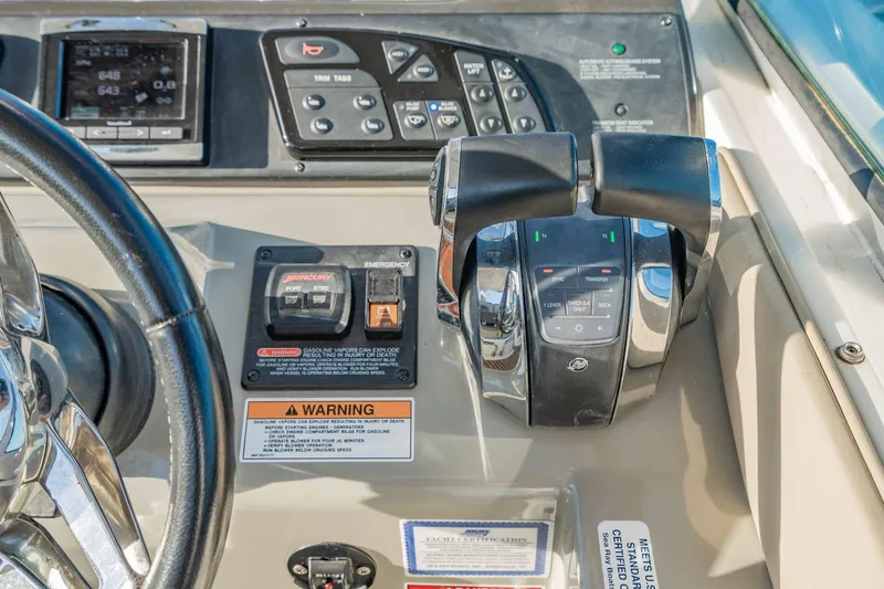 Slide: The Image of Control panel of a 2016 Sea Ray 370 Express Cruiser with steering wheel and throttle controls. - 24