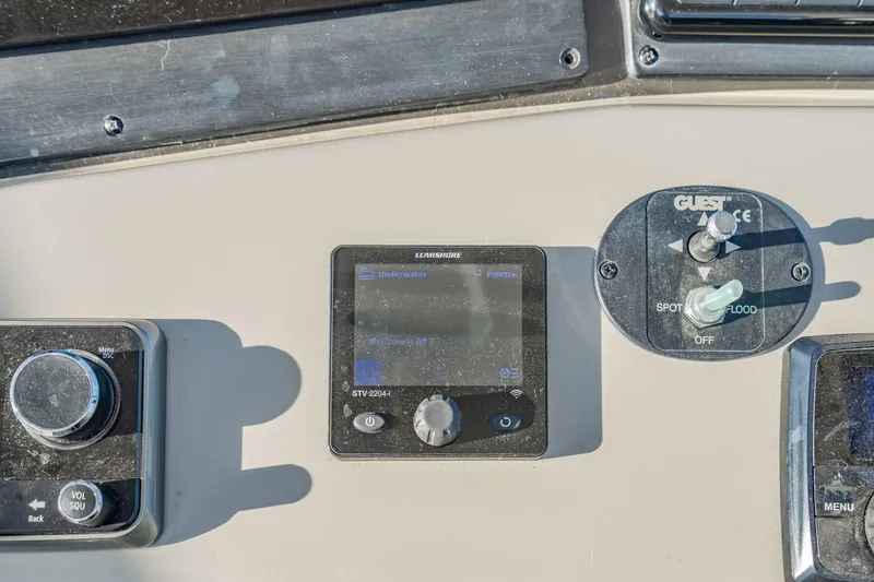 Slide: The Image of Control panel of a 2016 Sea Ray 370 Express Cruiser with electronic displays and switches. - 27