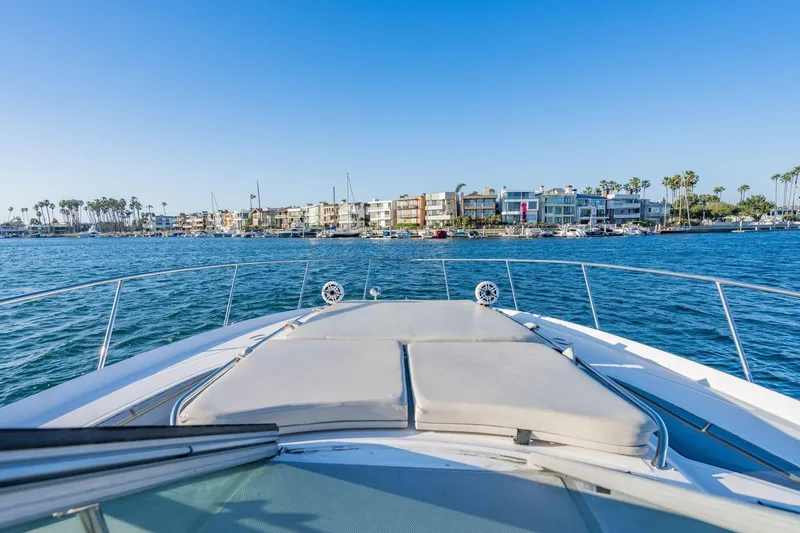 Slide: The Image of 2016 Sea Ray 370 Express Cruiser on water, coastal homes in background. - 29