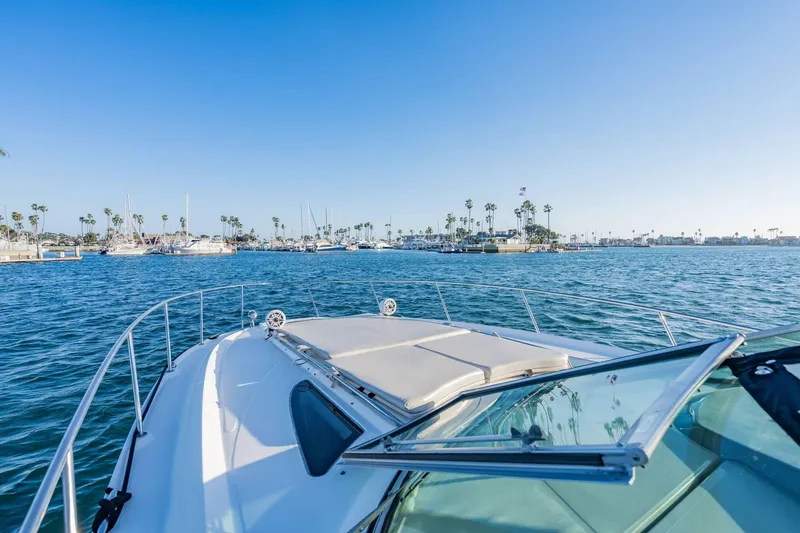 Slide: The Image of 2016 Sea Ray 370 Express Cruiser on calm waters with marina view. - 30