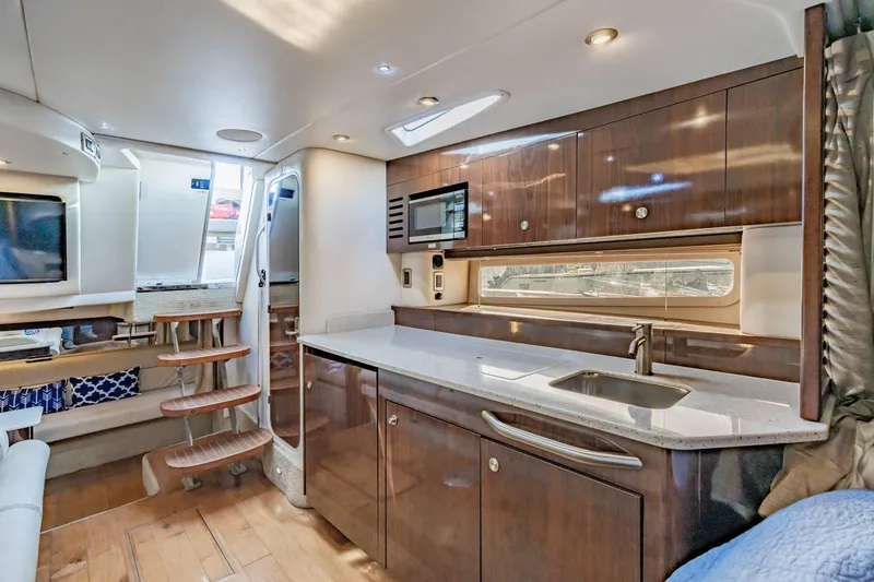 Slide: The Image of Luxurious interior of 2016 Sea Ray 370 Express Cruiser with modern kitchen and seating area. - 39