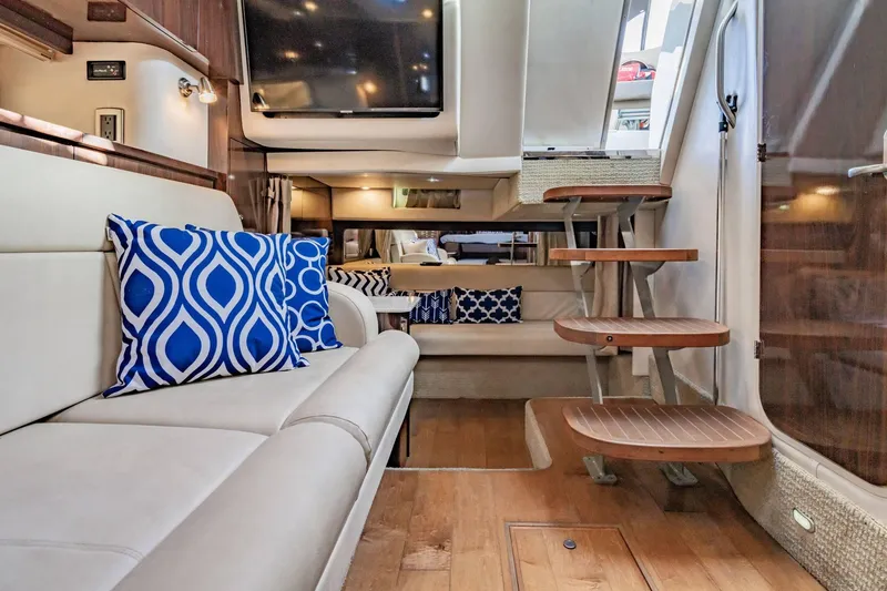Slide: The Image of Luxurious interior of 2016 Sea Ray 370 Express Cruiser with stylish seating and wooden steps. - 40