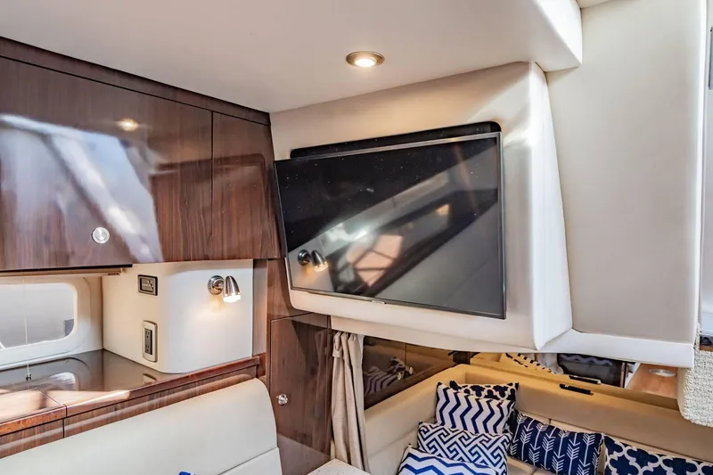 Slide: The Image of Luxurious interior of 2016 Sea Ray 370 Express Cruiser with TV and stylish cushions. - 44