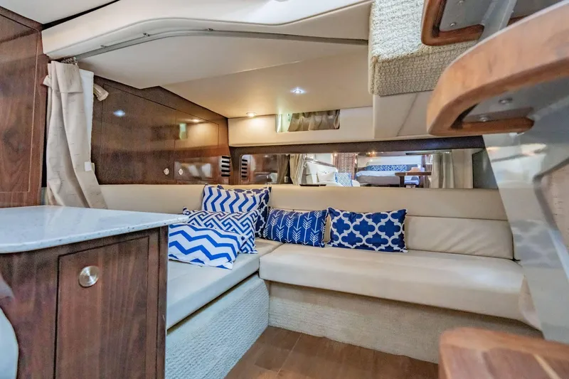 Slide: The Image of Luxurious interior of 2016 Sea Ray 370 Express Cruiser with stylish seating and decorative pillows. - 45