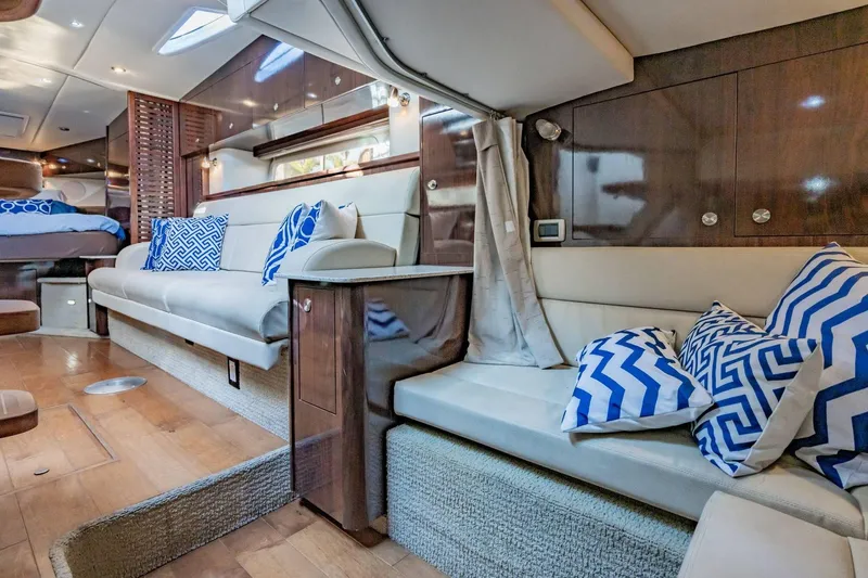 Slide: The Image of Luxurious interior of 2016 Sea Ray 370 Express Cruiser with stylish seating and blue accents. - 46