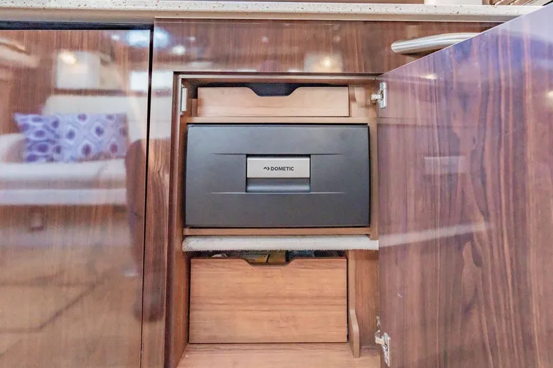 Slide: The Image of 2016 Sea Ray 370 Express Cruiser interior with Dometic appliance in wooden cabinet. - 54