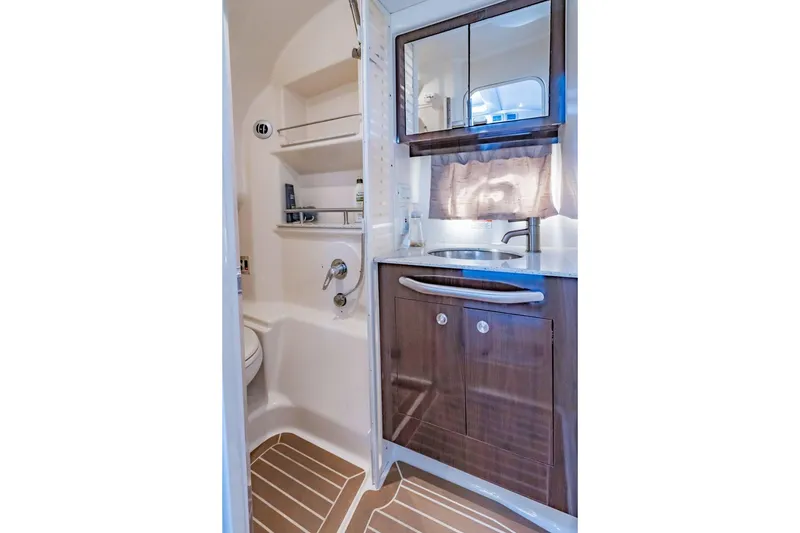 Slide: The Image of Luxurious bathroom in 2016 Sea Ray 370 Express Cruiser with modern fixtures and wood cabinetry. - 55