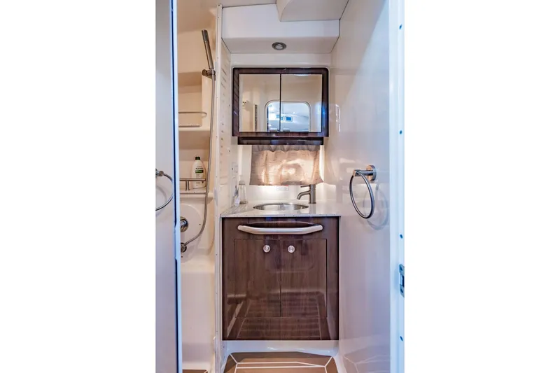 Slide: The Image of Bathroom interior of 2016 Sea Ray 370 Express Cruiser with modern fixtures and wooden cabinetry. - 56