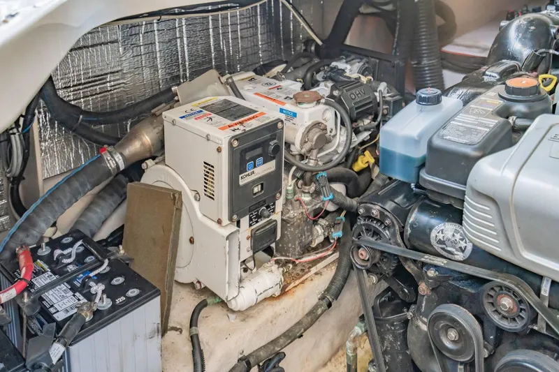 Slide: The Image of Engine compartment of a 2016 Sea Ray 370 Express Cruiser, featuring a Kohler generator. - 61