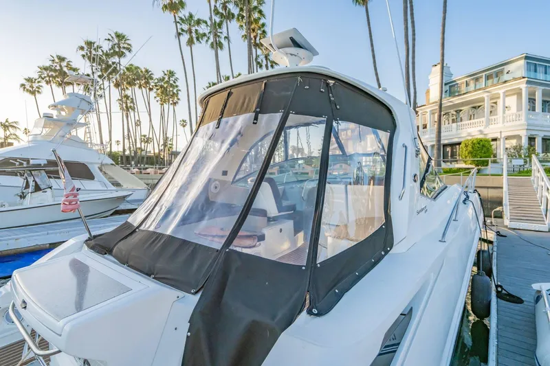 Slide: The Image of 2016 Sea Ray 370 Express Cruiser docked near palm trees and a waterfront building. - 9