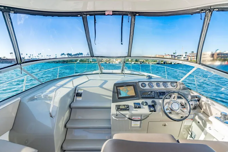 Slide: The Image of Cockpit view of 2016 Sea Ray 370 Express Cruiser on open water. - 19