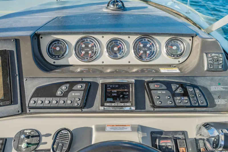 Slide: The Image of Control panel of a 2016 Sea Ray 370 Express Cruiser with gauges and navigation controls. - 23