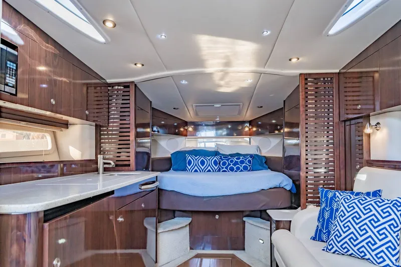Slide: The Image of Luxurious interior of 2016 Sea Ray 370 Express Cruiser with elegant wood finishes and plush bedding. - 35