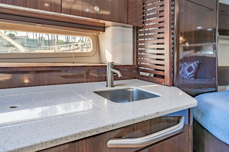 Slide: The Image of Luxurious interior of 2016 Sea Ray 370 Express Cruiser with modern kitchenette. - 43