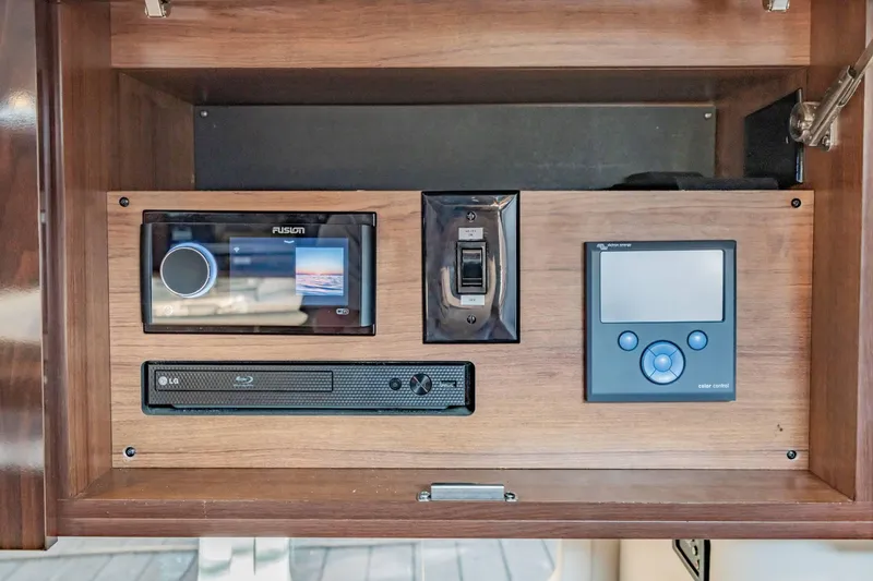 Slide: The Image of Control panel of a 2016 Sea Ray 370 Express Cruiser with audio and navigation systems. - 52