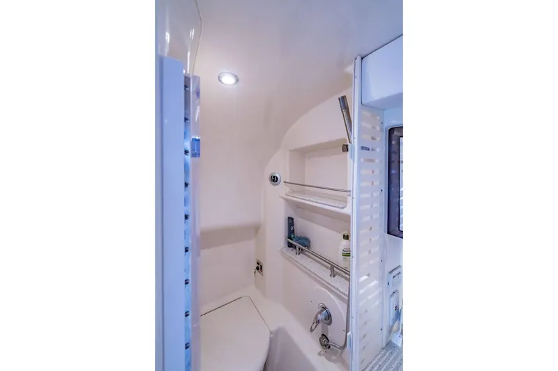 Slide: The Image of Bathroom interior of 2016 Sea Ray 370 Express Cruiser with shower and shelves. - 58