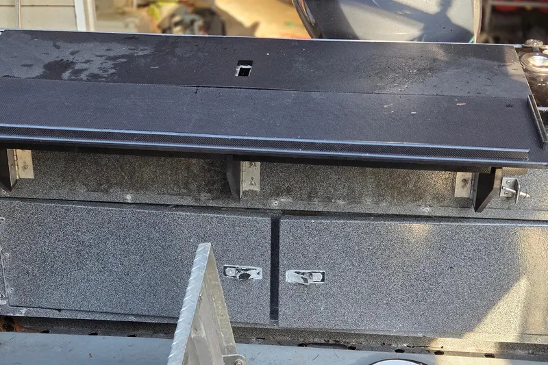 Slide: The Image of 2008 Alumaweld 22 Intruder boat interior with storage compartments and seating area. - 17