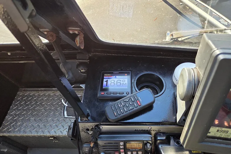 Slide: The Image of 2008 Alumaweld 22 Intruder dashboard with navigation equipment and controls. - 9