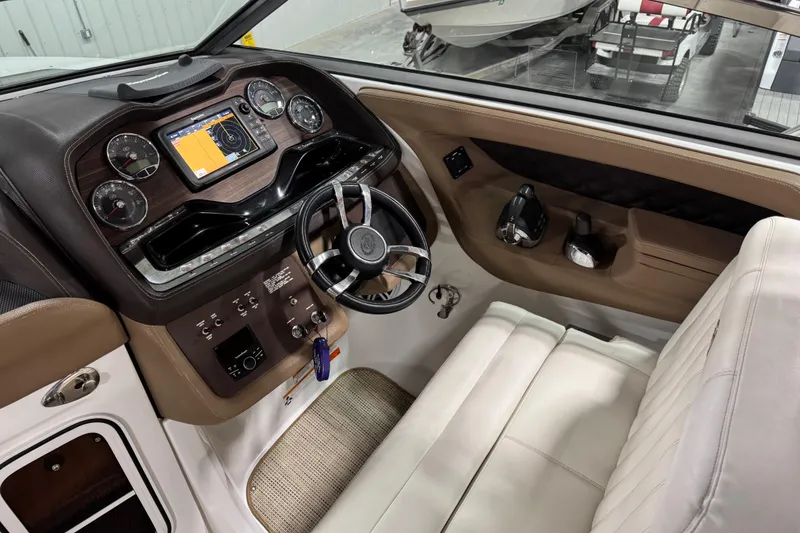 Slide: The Image of 2016 Cobalt 336 boat cockpit with steering wheel, gauges, and navigation display. - 10