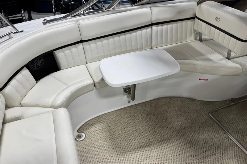 Slide: The Image of Luxurious seating area on a 2016 Cobalt 336 boat with white upholstery and table. - 11