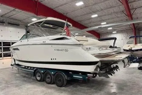 Slide: The Image of 2016 Cobalt 336 boat in a warehouse, on a trailer, with an American flag. - 25