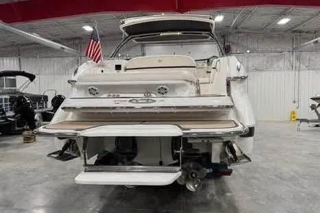 Slide: The Image of 2016 Cobalt 336 boat in a showroom, rear view with American flag. - 26