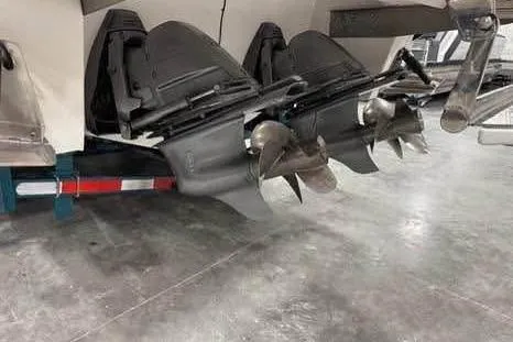 Slide: The Image of 2016 Cobalt 336 boat with dual outboard motors and propellers in a garage setting. - 27