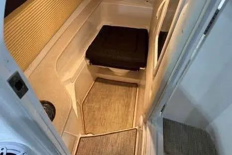 Slide: The Image of 2016 Cobalt 336 boat interior cabin with seating and carpeted floor. - 29