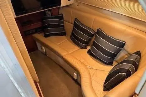Slide: The Image of 2016 Cobalt 336 interior with beige leather seating and striped cushions. - 30