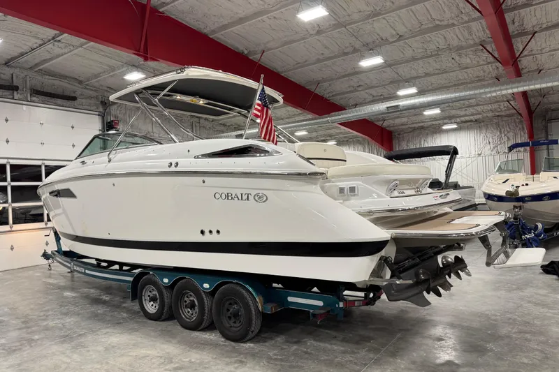 Slide: The Image of 2016 Cobalt 336 boat in a showroom, on a trailer, with an American flag. - 4