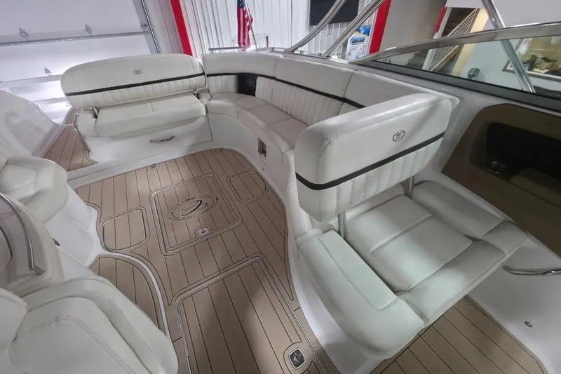 Slide: The Image of Luxurious interior of a 2016 Cobalt 336 boat with white leather seating and wood flooring. - 42
