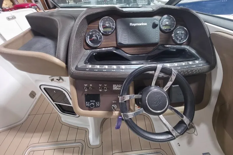 Slide: The Image of 2016 Cobalt 336 boat dashboard with Raymarine navigation system and modern steering wheel. - 43