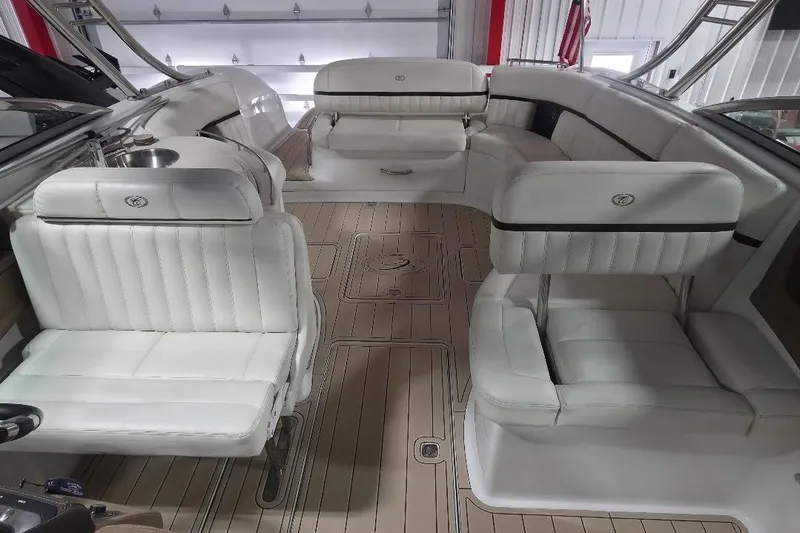 Slide: The Image of Interior of a 2016 Cobalt 336 boat with white leather seating and wood flooring. - 46