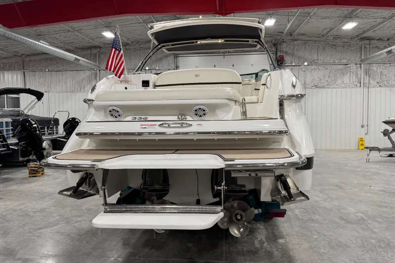 Slide: The Image of 2016 Cobalt 336 boat in showroom, rear view with American flag. - 5
