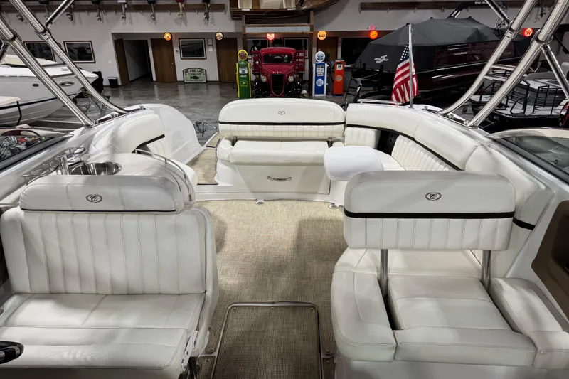 Slide: The Image of Interior of a 2016 Cobalt 336 boat with white leather seating and American flag. - 7