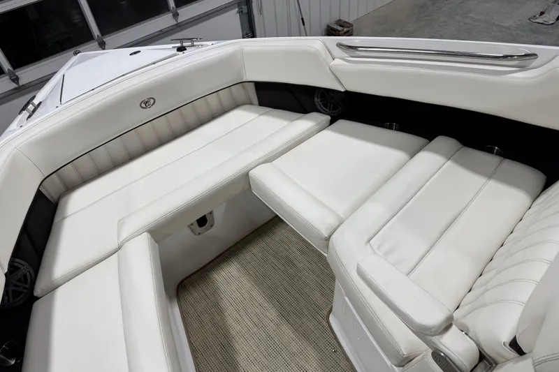 Slide: The Image of 2016 Cobalt 336 boat interior with white leather seating and carpeted flooring. - 8