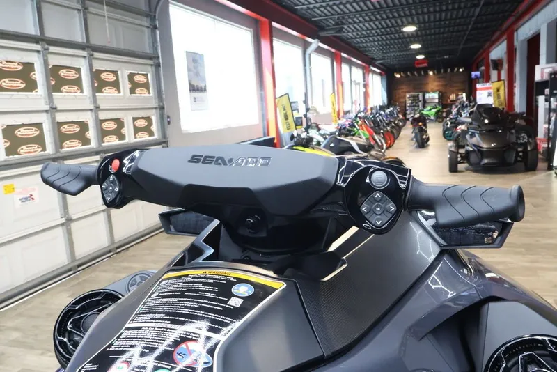 Slide: The Image of 2026 Sea-Doo GTX 230 in showroom, close-up of handlebars. - 13
