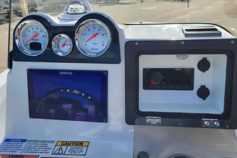 Slide: The Image of Dashboard of 2025 NauticStar 191 Hybrid boat with gauges and navigation system. - 11