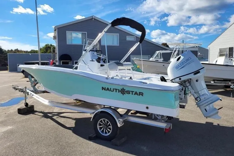 Slide: The Image of 2025 NauticStar 191 Hybrid boat on trailer, featuring Suzuki outboard motor. - 3