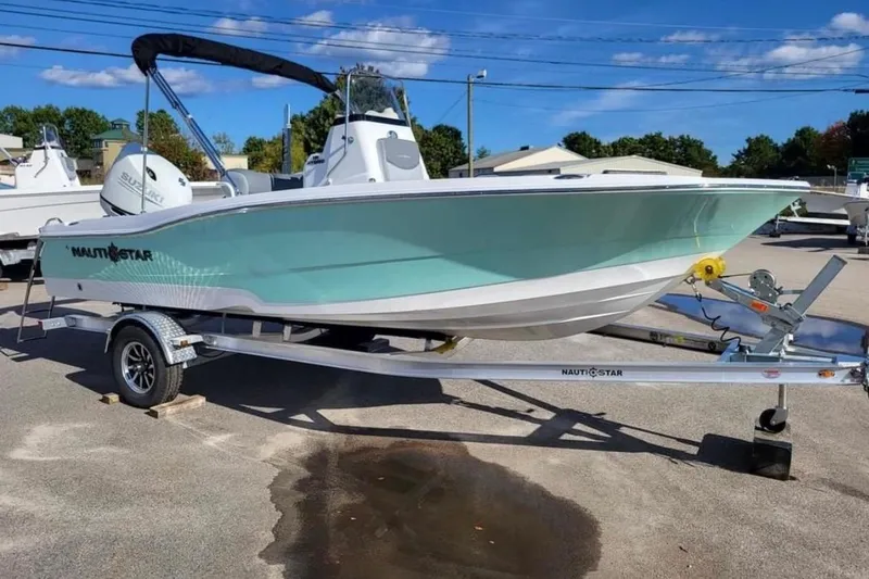 Slide: The Image of 2025 NauticStar 191 Hybrid boat on trailer, light blue hull, sunny day. - 5