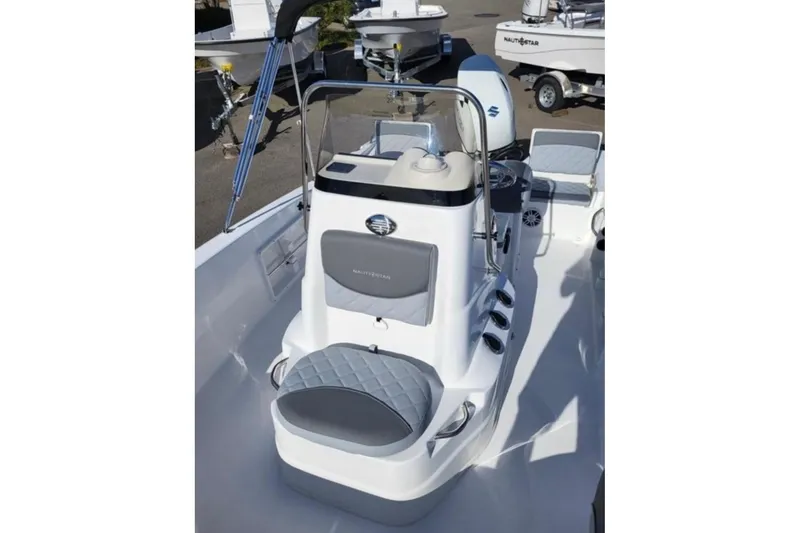 Slide: The Image of 2025 NauticStar 191 Hybrid boat interior with seating and console, showcasing modern design. - 9