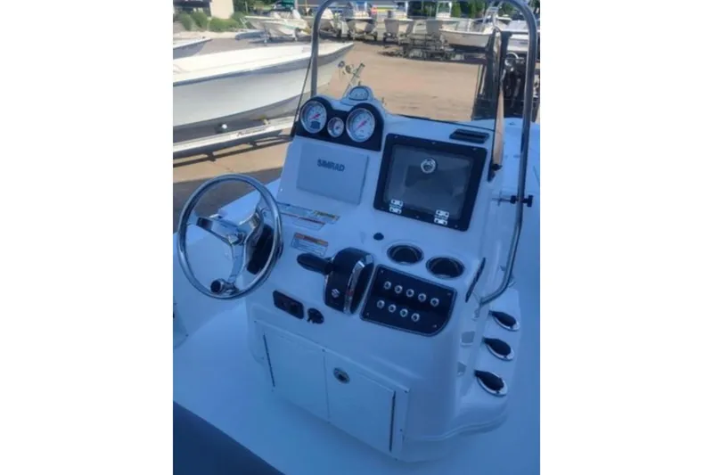 Slide: The Image of 2024 NauticStar 194 Bay boat console with steering wheel and navigation controls. - 5