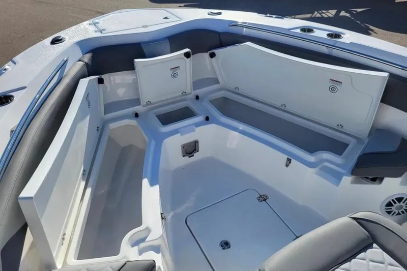 Slide: The Image of 2025 NauticStar 222 Offshore boat interior with open storage compartments and seating. - 7