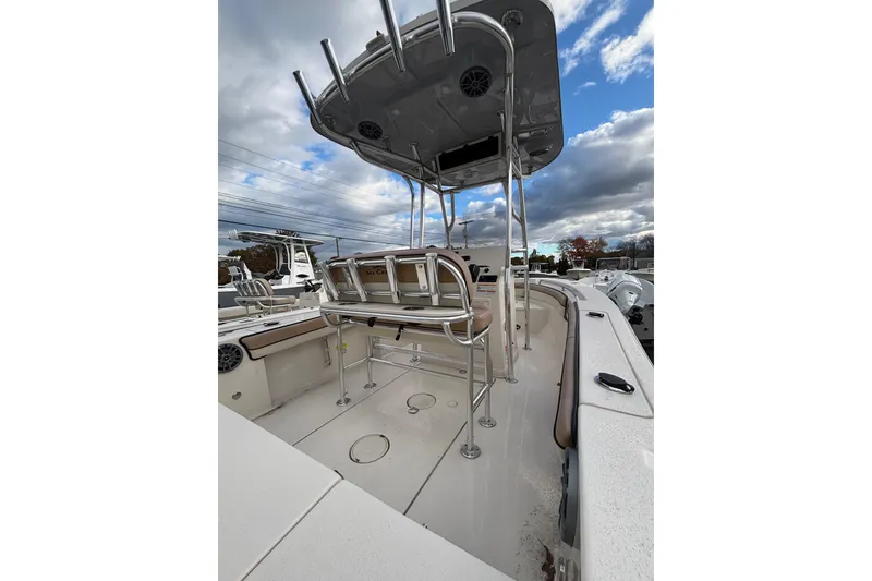 Slide: The Image of 2023 Sea Chaser 20 HFC boat interior with T-top and seating, under cloudy sky. - 4