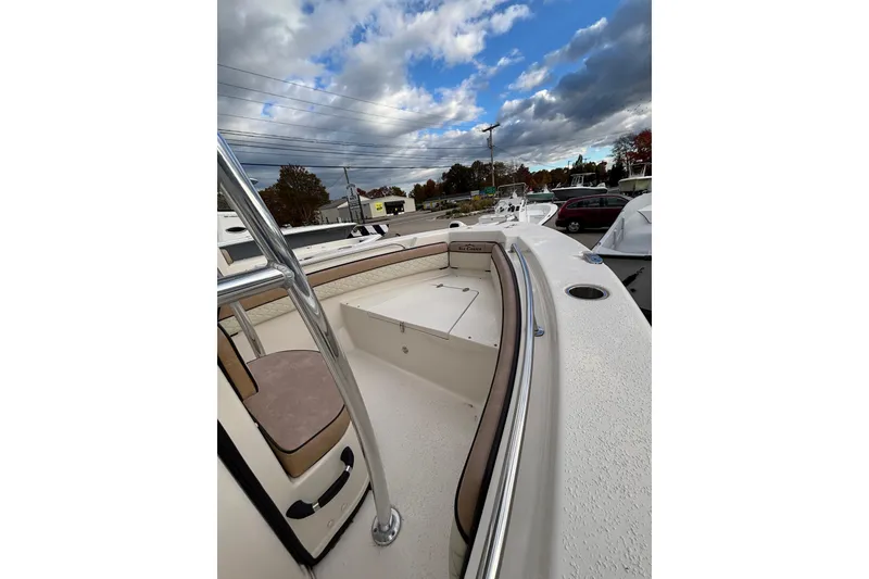 Slide: The Image of 2023 Sea Chaser 20 HFC boat deck with seating, under a partly cloudy sky. - 7