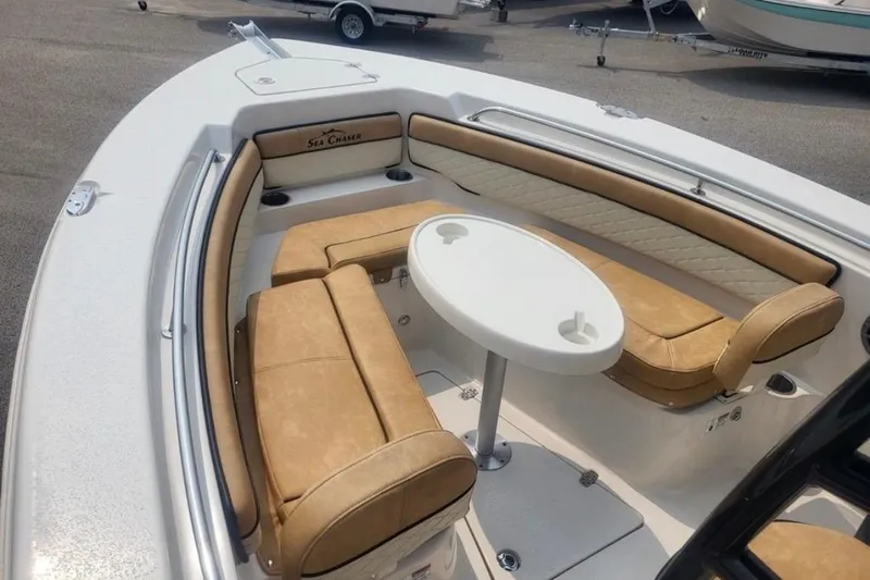 Slide: The Image of 2023 Sea Chaser 22 HFC boat interior with tan seating and round table. - 5