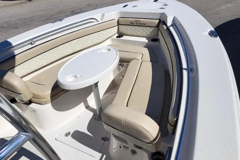 Slide: The Image of 2023 Sea Chaser 22 HFC boat interior with beige seating and round table. - 5