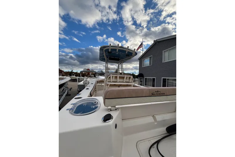 Slide: The Image of 2023 Sea Chaser 24 HFC boat docked under cloudy sky. - 5