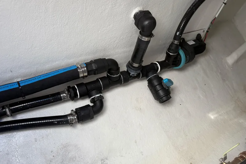 Slide: The Image of Plumbing system in 2025 Pair Customs 28 Center Console boat, featuring black pipes and connectors. - 11