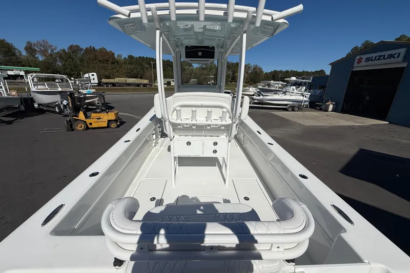 Slide: The Image of 2025 Pair Customs 28 Center Console boat at a marina with Suzuki signage. - 13